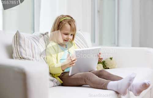 Image of little girl with tablet computer at home