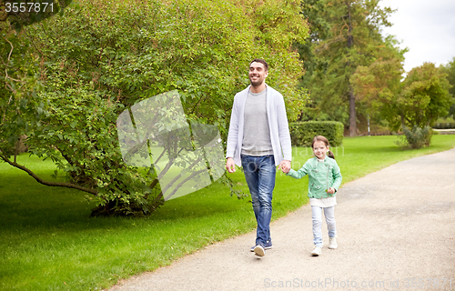 Image of happy family walking in summer park