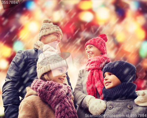 Image of happy family in winter clothes outdoors