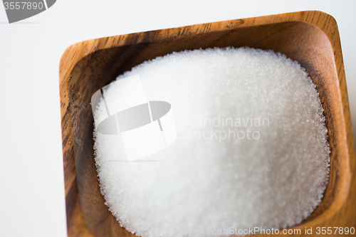 Image of close up of white sugar heap in wooden bowl