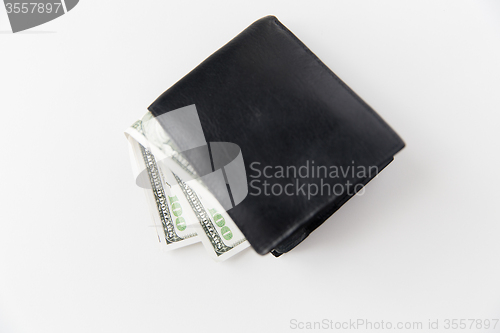 Image of close up of dollar money in black wallet on table