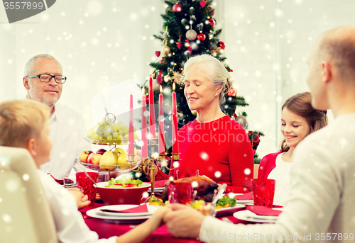 Image of smiling family having holiday dinner at home