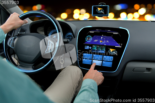 Image of close up of man driving car with navigation system