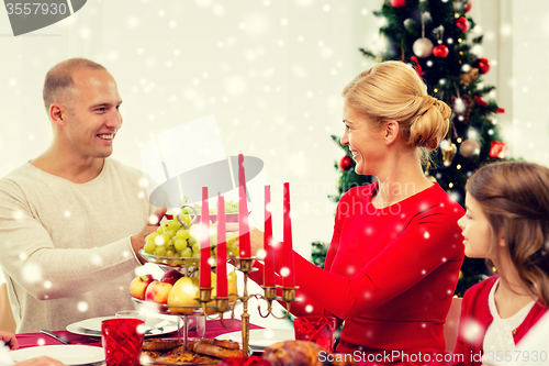 Image of smiling family having holiday dinner at home