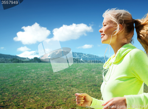 Image of happy sporty woman running or jogging outdoors