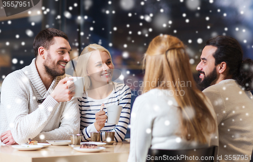 Image of happy friends meeting and drinking tea or coffee