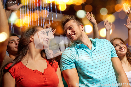 Image of happy couple having fun at music concert in club