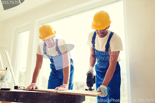 Image of group of builders with tools indoors