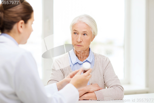 Image of doctor with medicine and senior woman at hospital