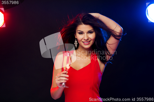 Image of beautiful woman with champagne glass at nightclub