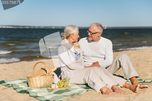 Image of happy senior couple talking on summer beach