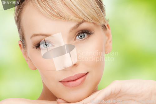 Image of beautiful young woman face over green background