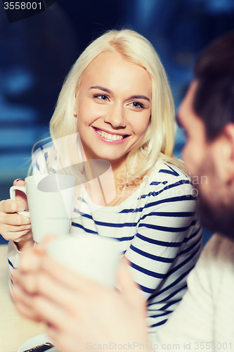 Image of happy couple meeting and drinking tea or coffee