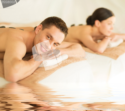 Image of couple in spa with hot stones