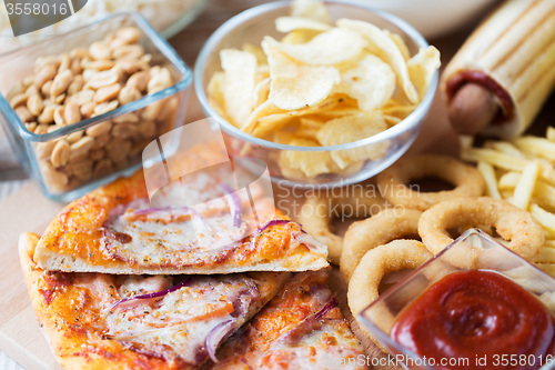 Image of close up of fast food snacks on wooden table