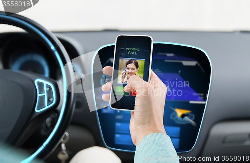 Image of close up of man with call on smartphone in car