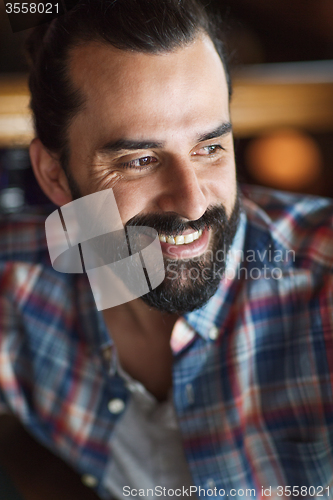 Image of happy young man with beard and mustache