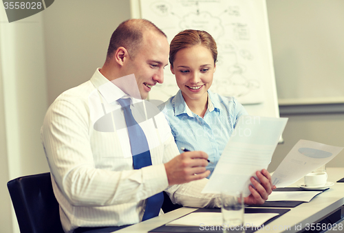 Image of business people with papers meeting in office