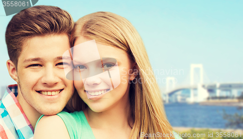 Image of smiling couple over rainbow bridge in tokyo