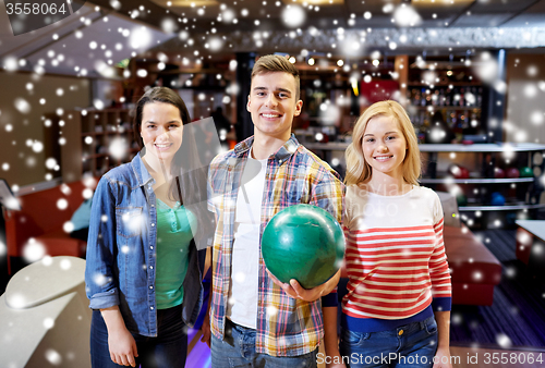 Image of happy friends in bowling club at winter season