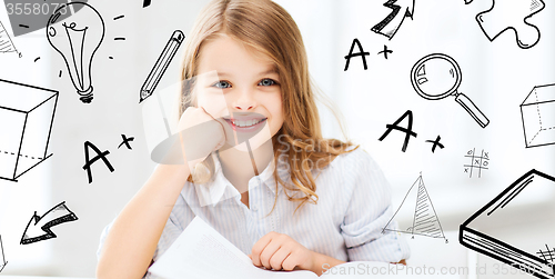 Image of little student girl studying at school