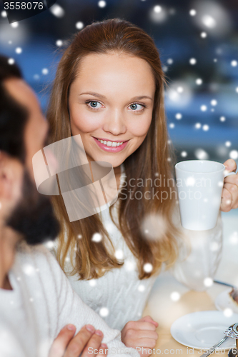 Image of happy couple meeting and drinking tea or coffee