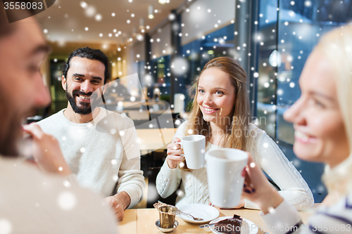 Image of happy friends meeting and drinking tea or coffee