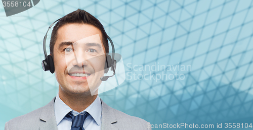 Image of happy businessman in headset over grid background