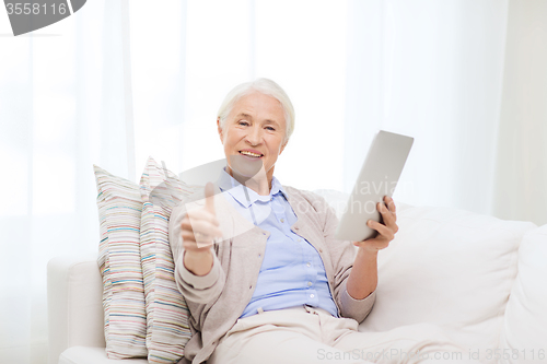 Image of senior woman with tablet pc showing thumbs up 