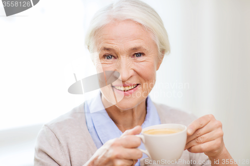 Image of happy senior woman with cup of coffee