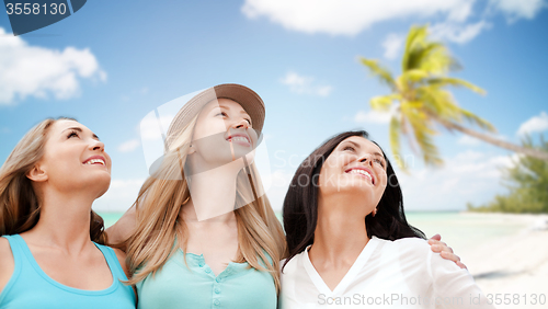 Image of group of happy young women over summer beach