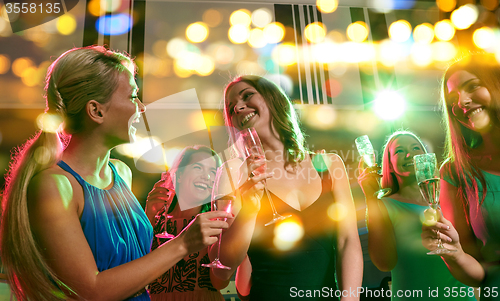 Image of young women with glasses of champagne in club