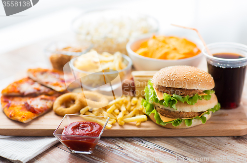 Image of close up of fast food snacks and drink on table