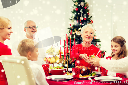 Image of smiling family having holiday dinner at home