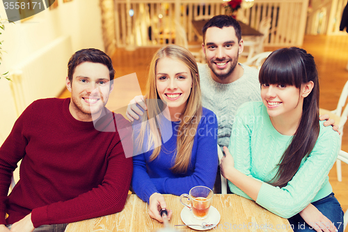 Image of group of friends taking picture with selfie stick