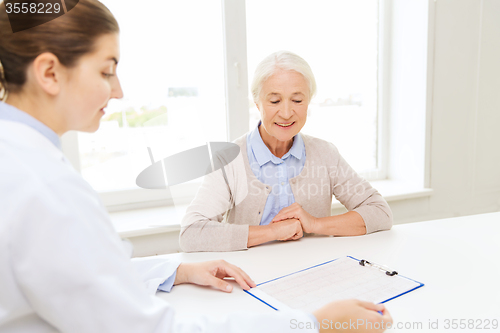 Image of doctor with clipboard and senior woman at hospital