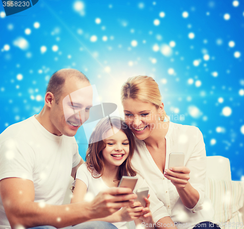 Image of happy family with smartphones