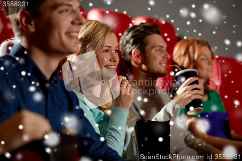 Image of happy friends with popcorn and drinks in cinema