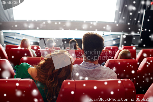 Image of happy couple watching movie in theater or cinema