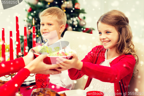 Image of smiling family having holiday dinner at home