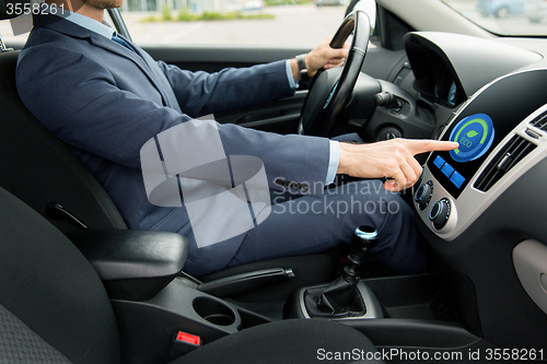 Image of close up of man  driving car in eco mode