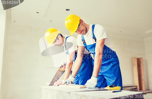 Image of group of builders with tools indoors