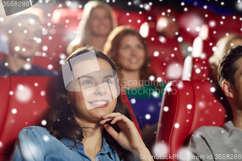 Image of happy woman watching movie in theater