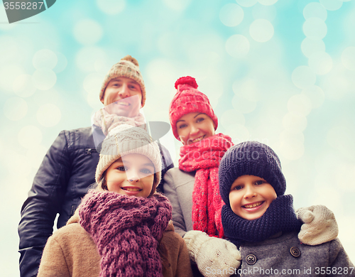 Image of happy family in winter clothes outdoors