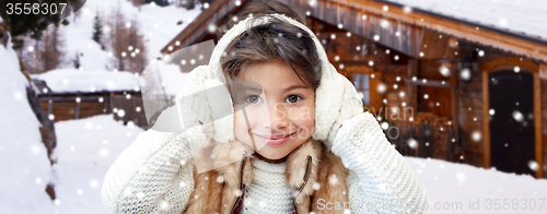 Image of happy little girl wearing earmuffs