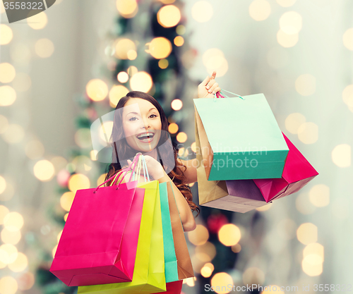 Image of smiling woman with colorful shopping bags