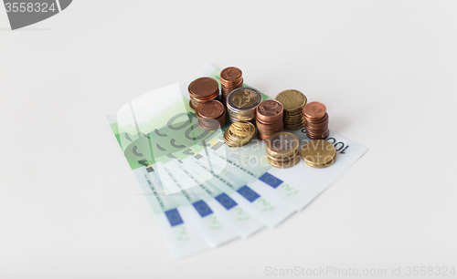 Image of close up of euro paper money and coins on table