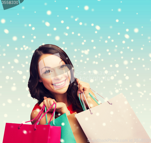 Image of woman in red dress with shopping bags