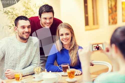 Image of group of friends taking picture with smartphone