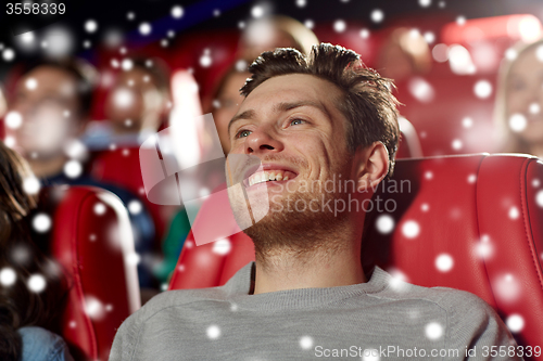 Image of happy young man watching movie in theater